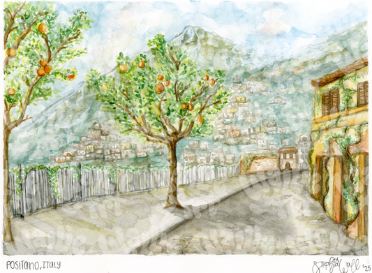Watercolor painting of a cobble-stone street scene with orange trees and buildings in Positano, Italy. In the distance there is a mountain covered in little houses, with a slight fog over the mountains. It is signed by "Sophia Wall" with the date '25